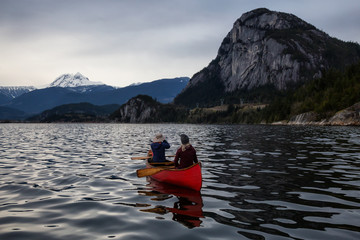 Adventurous people on a canoe are enjoying the beautiful Canadian Mountain Landscape. Taken in Squamish, North of Vancouver, British Columbia, Canada.