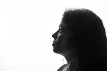 Portrait of a young woman looking up - horizontal silhouette on white background