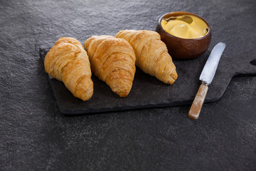 Croissants with butter and knife