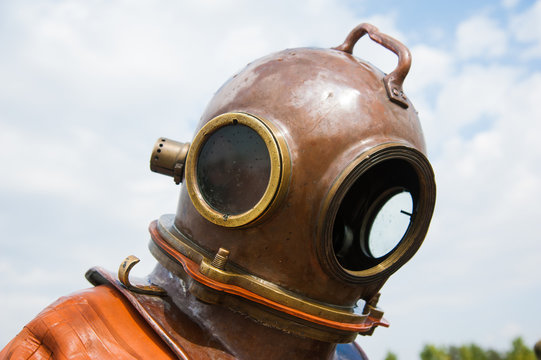 Diver immerses in a vintage deep sea diving suit