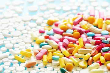 Colorful pills on a blue background