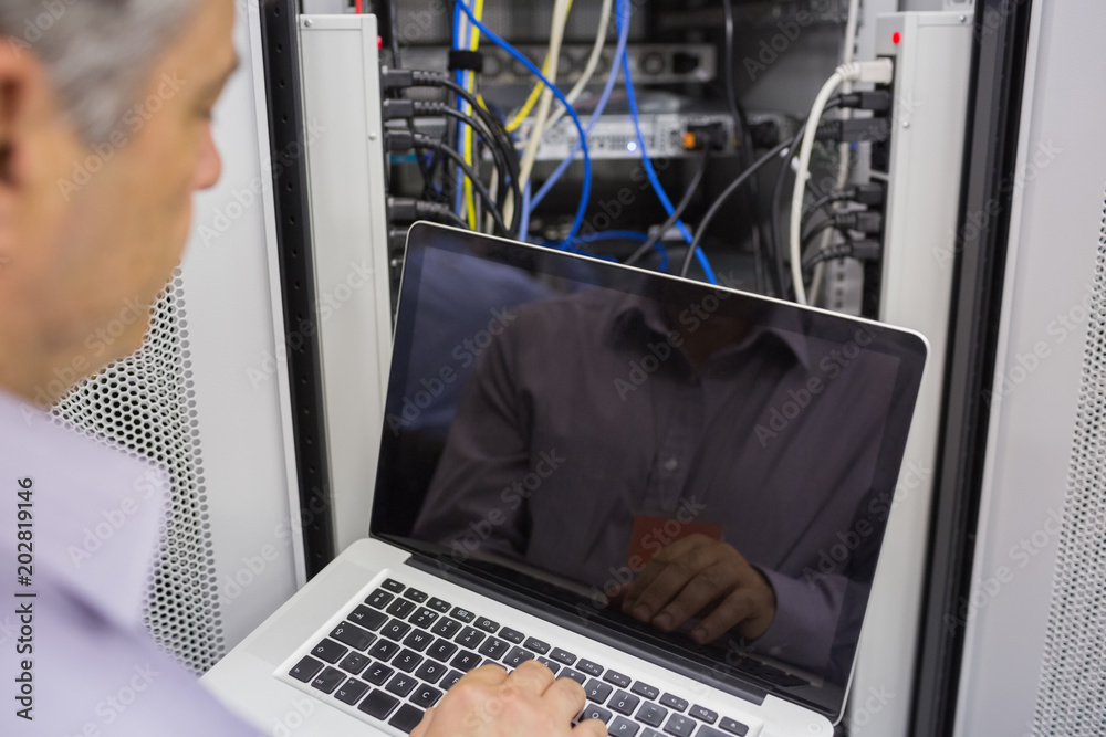 Aufkleber Man sitting in front of a laptop doing server maintenance