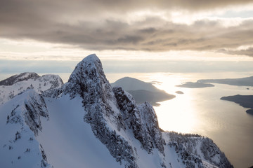 Aerial view of the beautiful Canadian Mountain Landscape during a vibrant cloudy day. Taken North of Vancouver, British Columbia, Canada. © edb3_16
