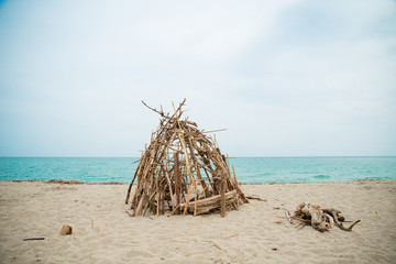 robinson crusoe refugee handmade shelter by the sea in abandoned shore of isolated island