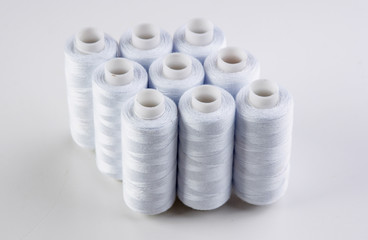 bobbin with white thread on a white background