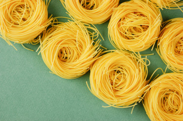 Tagliatelle pasta background on the green background
