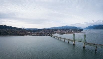 Fototapeta na wymiar Aerial panorama of a bridge going over Columbian River between Oregon and Washington during a winter day.