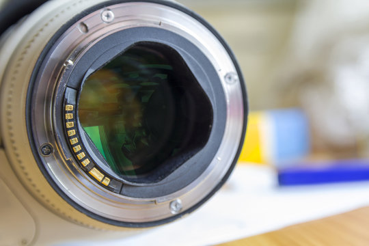 Close up of camera lens on blurred background.