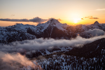Striking and beautiful aerial landscape view of Canadian Mountains during a vibrant sunsetd. Taken North of Vancouver, British Columbia, Canada.