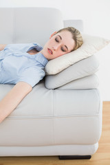 Obraz na płótnie Canvas Young classy businesswoman sleeping on her couch