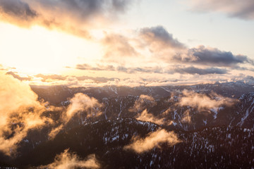 Fototapeta premium Striking and beautiful aerial landscape view of Canadian Mountains during a vibrant sunsetd. Taken North of Vancouver, British Columbia, Canada.