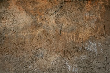 old plastered wall with stains and damage.