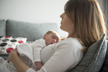 Young Mother Caring for her First Baby Boy
