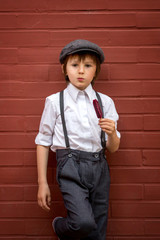 Little preschool boy, cute child, dressed in vintage style clothes, eating ice cream