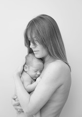 Young Mother Caring for her First Baby Boy