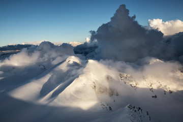 Striking and beautiful snow covered Canadian mountain landscape. Taken from an Aerial perspective North of Vancouver, British Columbia, Canada.