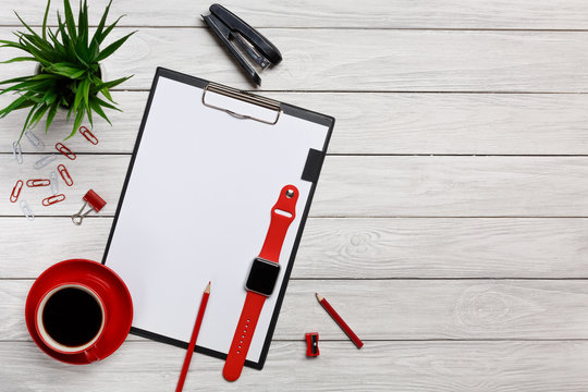 white table boards folders red notebook cup morning coffee clock paper clips keyboard mouse office worker office