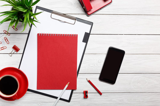 white desk boards folder red notepad cup morning coffee clock paper clip workflow meeting