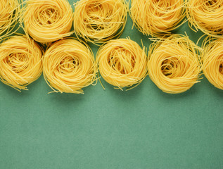 Tagliatelle pasta background on the green background