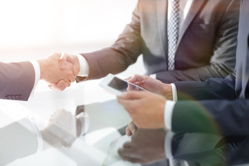 Two confident businessmen shaking hands during a meeting in the