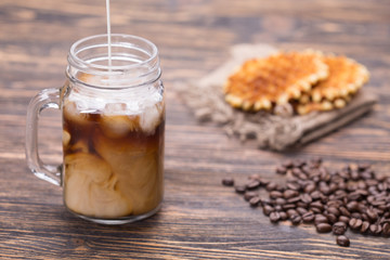 Milk is poured into coffee