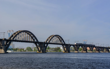 Suburban passenger train on the Merefa-Kherson bridge across the Dnieper River