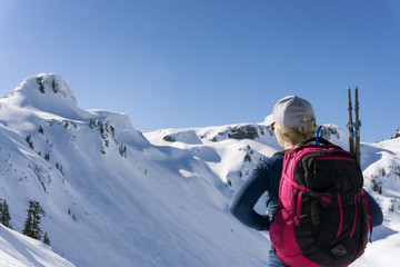 Fototapeta na wymiar Adventurous woman is snowshoeing in the beautiful mountainous landscape. Taken in Artist Point, Northeast of Seattle, Washington, United States of America.