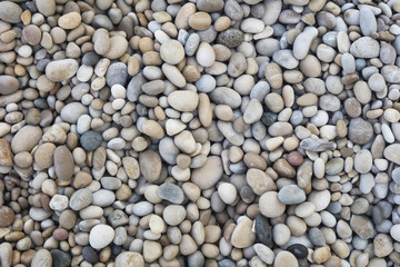 Closeup of pebble stones texture on a sunny day