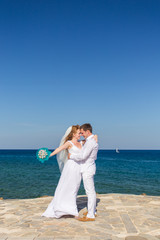 Bride and groom by the sea on their wedding day