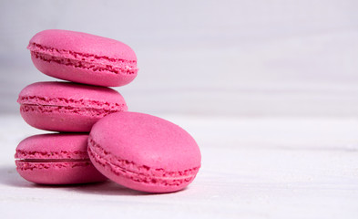 Cake macaroon pink color on white wooden background