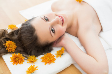 Obraz na płótnie Canvas Brunette lying on massage table in beauty salon