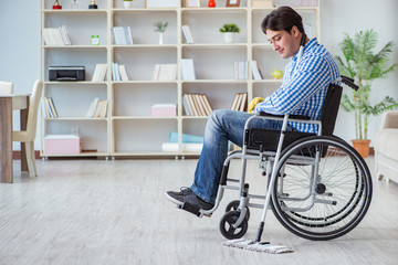 Fototapeta na wymiar Disabled man on wheelchair cleaning home
