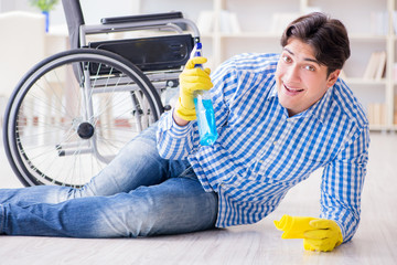 Disabled man on wheelchair cleaning home