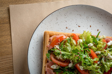 Homemade Belgian Waffle with salad Iceberg, tomatoes and ham