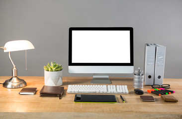 Desktop pc with table lamp and office stationery 