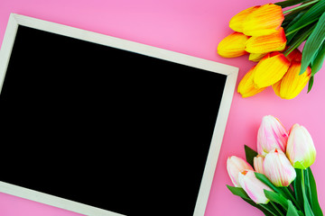 Beautiful of yellow tulip flower and chalkboard, blackboard with flat lay on the pink background, top view, copy space, mother day and holiday concept.
