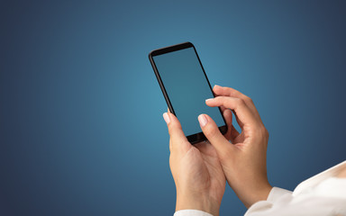 Mockup for female hand using frameless smartphone with dark background
