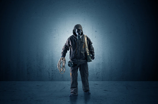 Bad agent in a dark room with arms on his hand and gas mask
