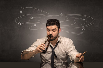 Young drunk man at his office with doodles around
