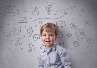 Smart little junior in front of a drawn up grey wall with childlike concept