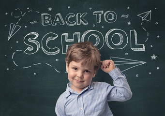 Adorable little boy with blackboard and back to school concept