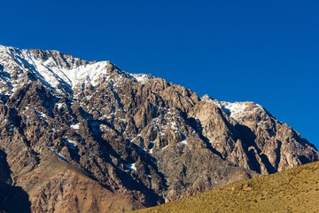 Snow peaks of Andes mountain range under intense blue sky in Elqui Valley, Chile. Exploration hike, trekking adventure concept