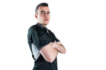 Fototapeta premium Frowning rugby player with arms crossed