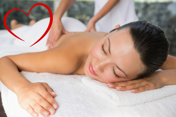 Fototapeta na wymiar Content brunette enjoying a back massage against heart