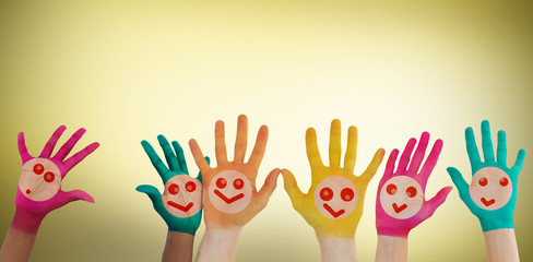 Hands with colourful smiley faces against yellow vignette - Powered by Adobe