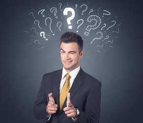 Young businessman with white question marks above his head