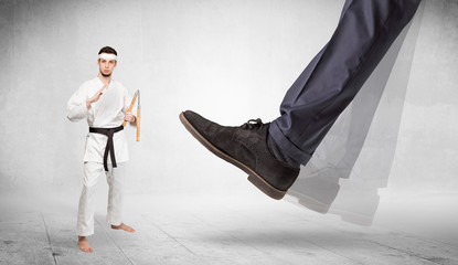 Big foot trample young karate trainer concept
