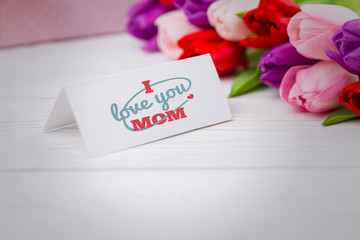 mothers day greeting against tulips with card