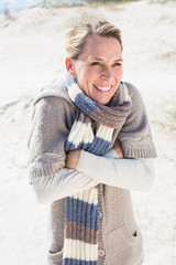 Attractive shivering blonde standing on the beach
