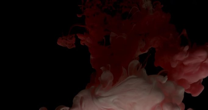 Red and white ink spraying in water on black background shooting with 4k high speed camera.